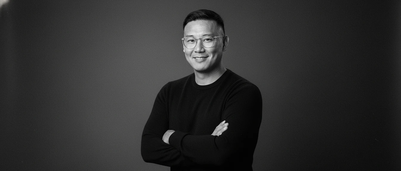 JC Navarro smiling in a black-and-white portrait